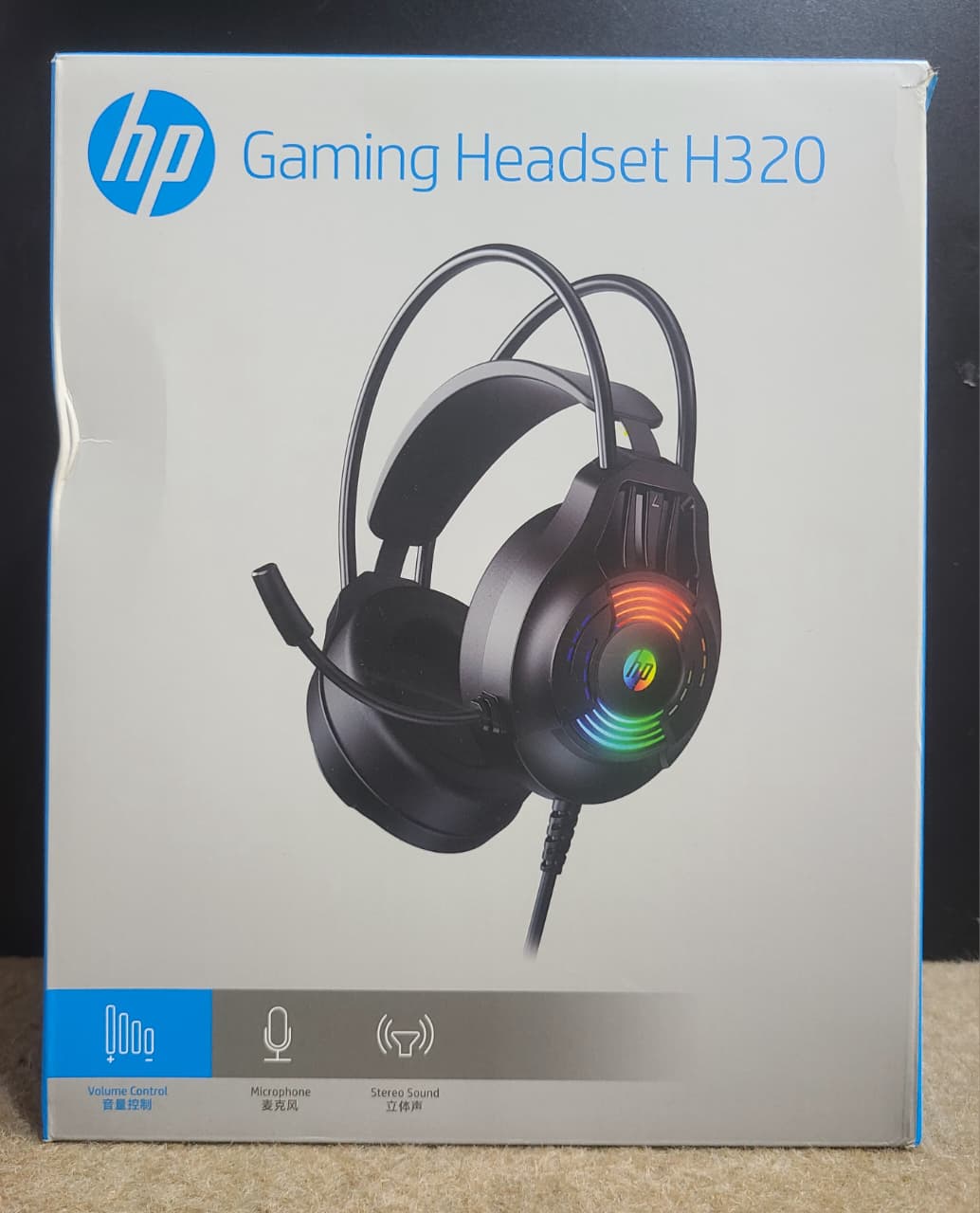 HP H320 gaming headset retail box showing round earcups and boom microphone
